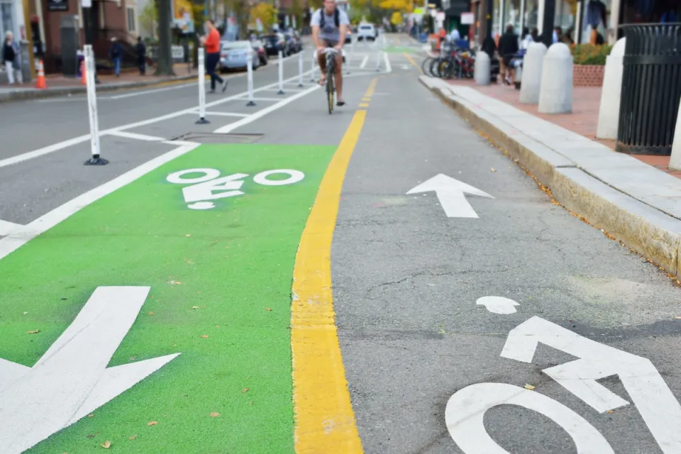 Two-way green painted bike lane in city.